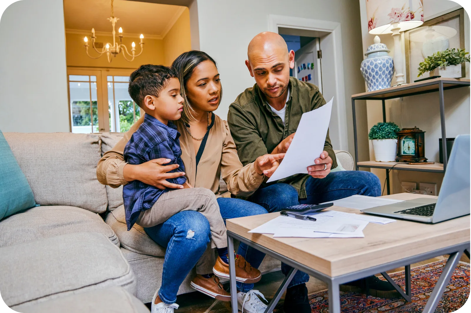 Mom and dad budgeting with child sitting on mother's lap.