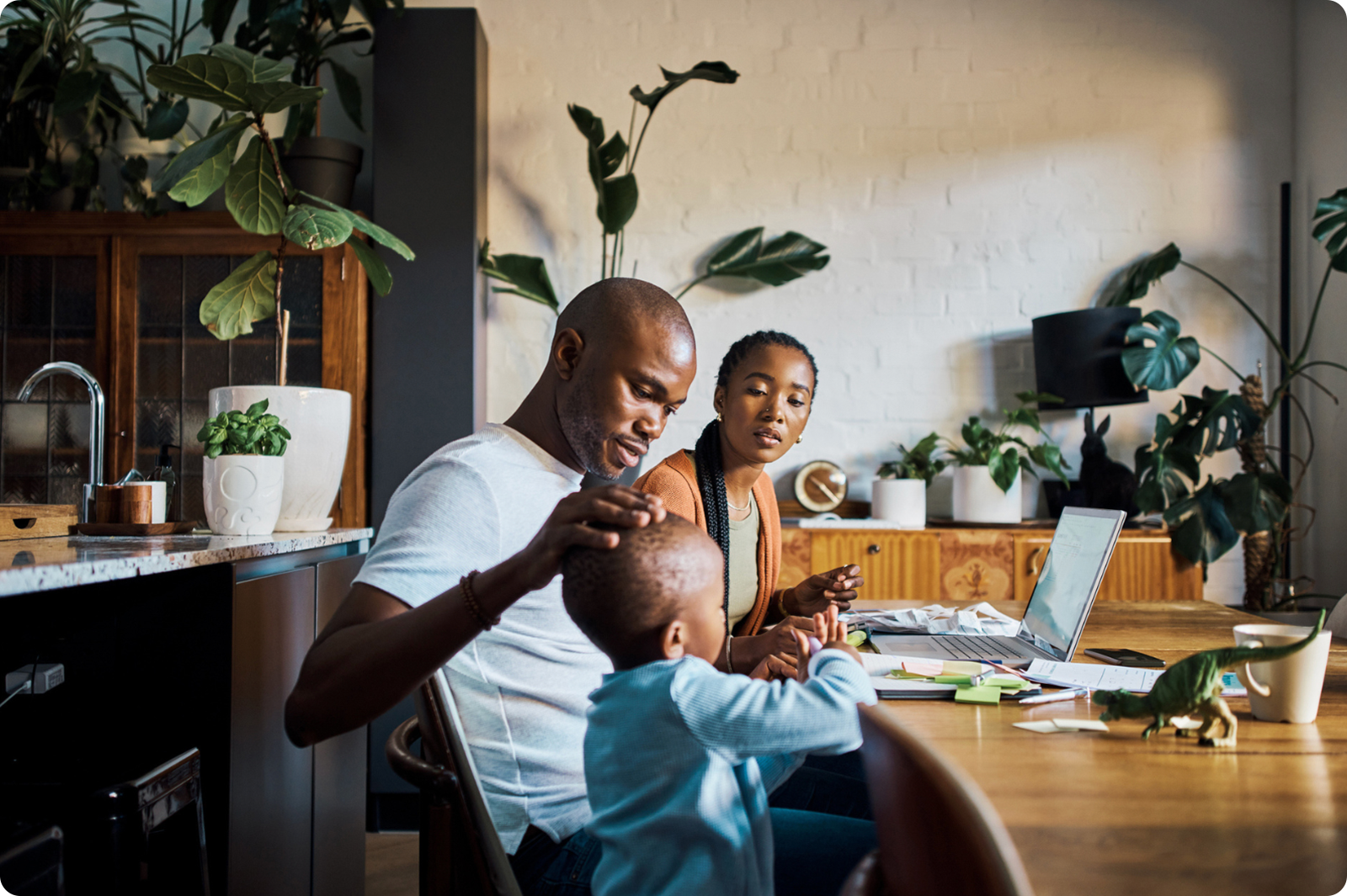 family managing finances while toddler looks around curious