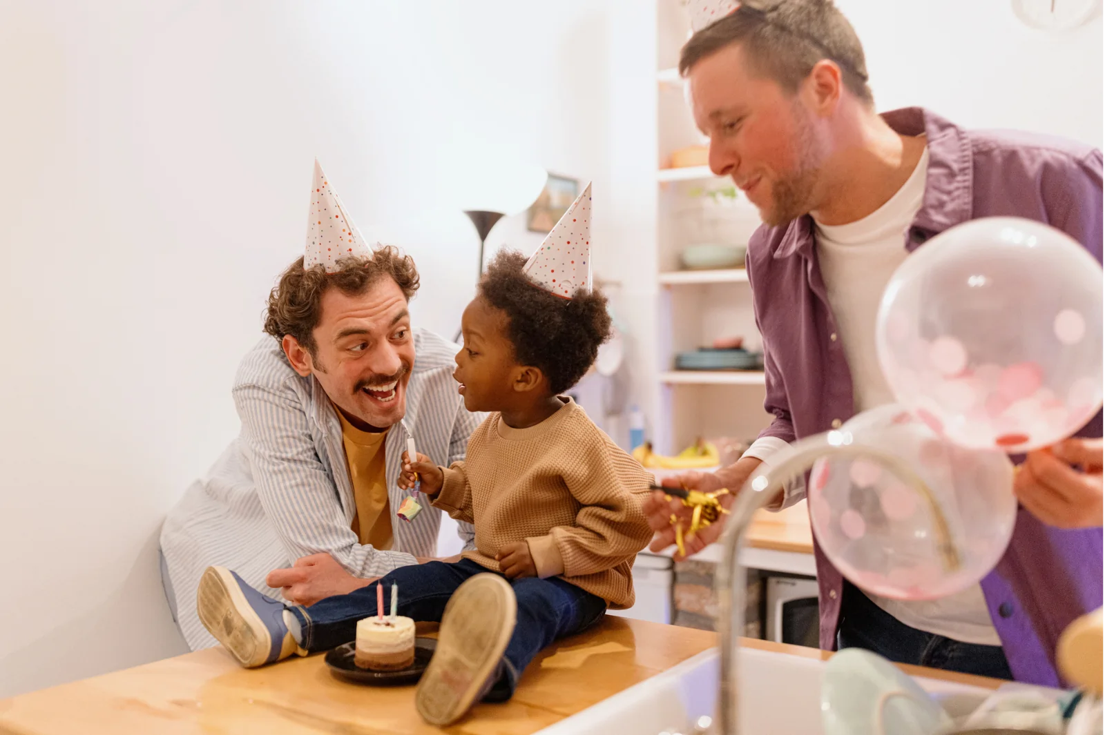 Two fathers celebrating their child's birthday