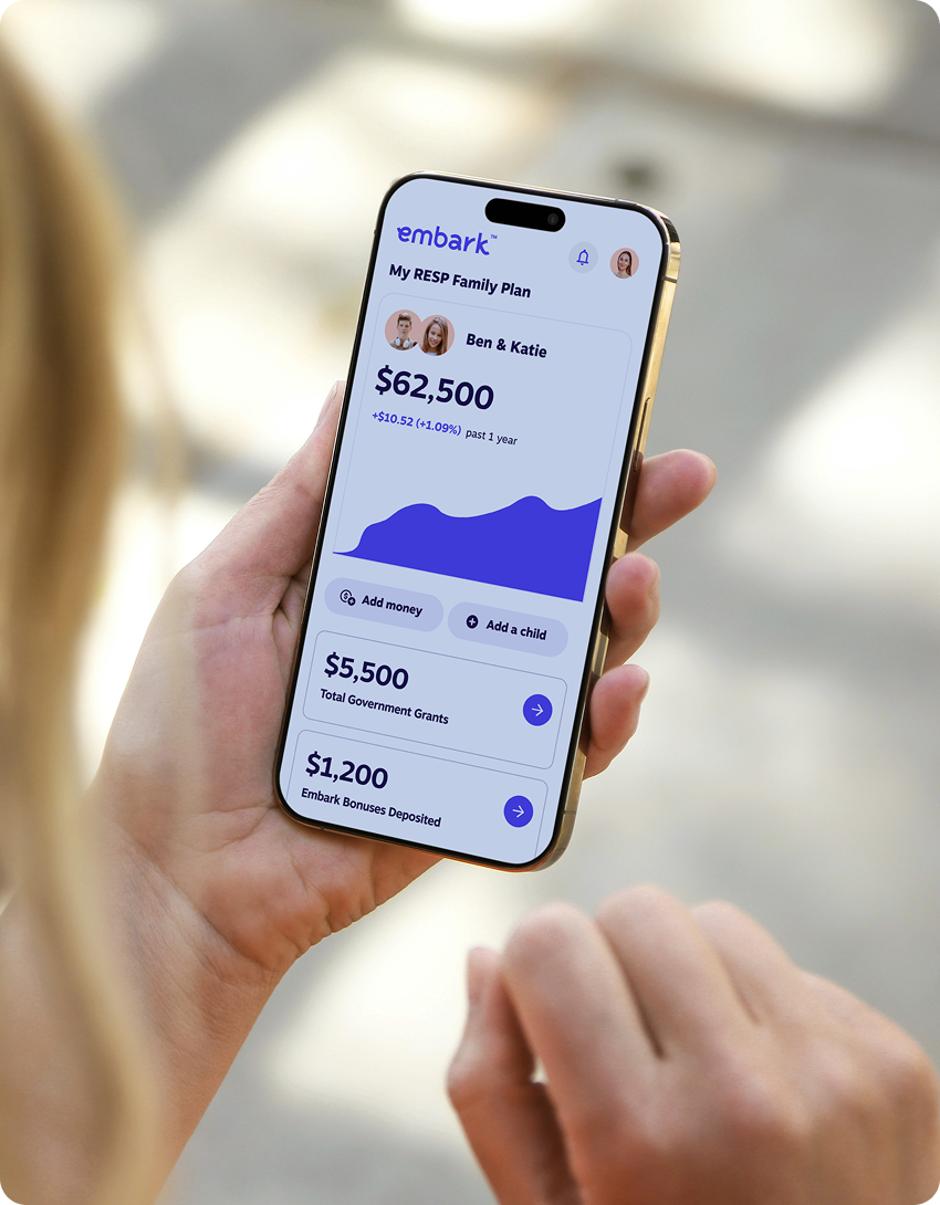 Close-up of a woman holding a smartphone displaying the Embark RESP app, showing savings progress for two children.