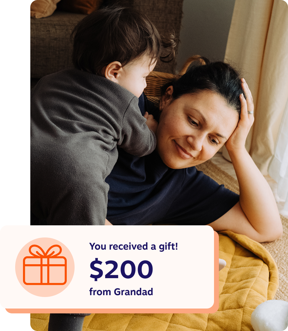 A young person beams with joy while looking at a RESP gift for their child from their dad, showcasing a moment of love and surprise.