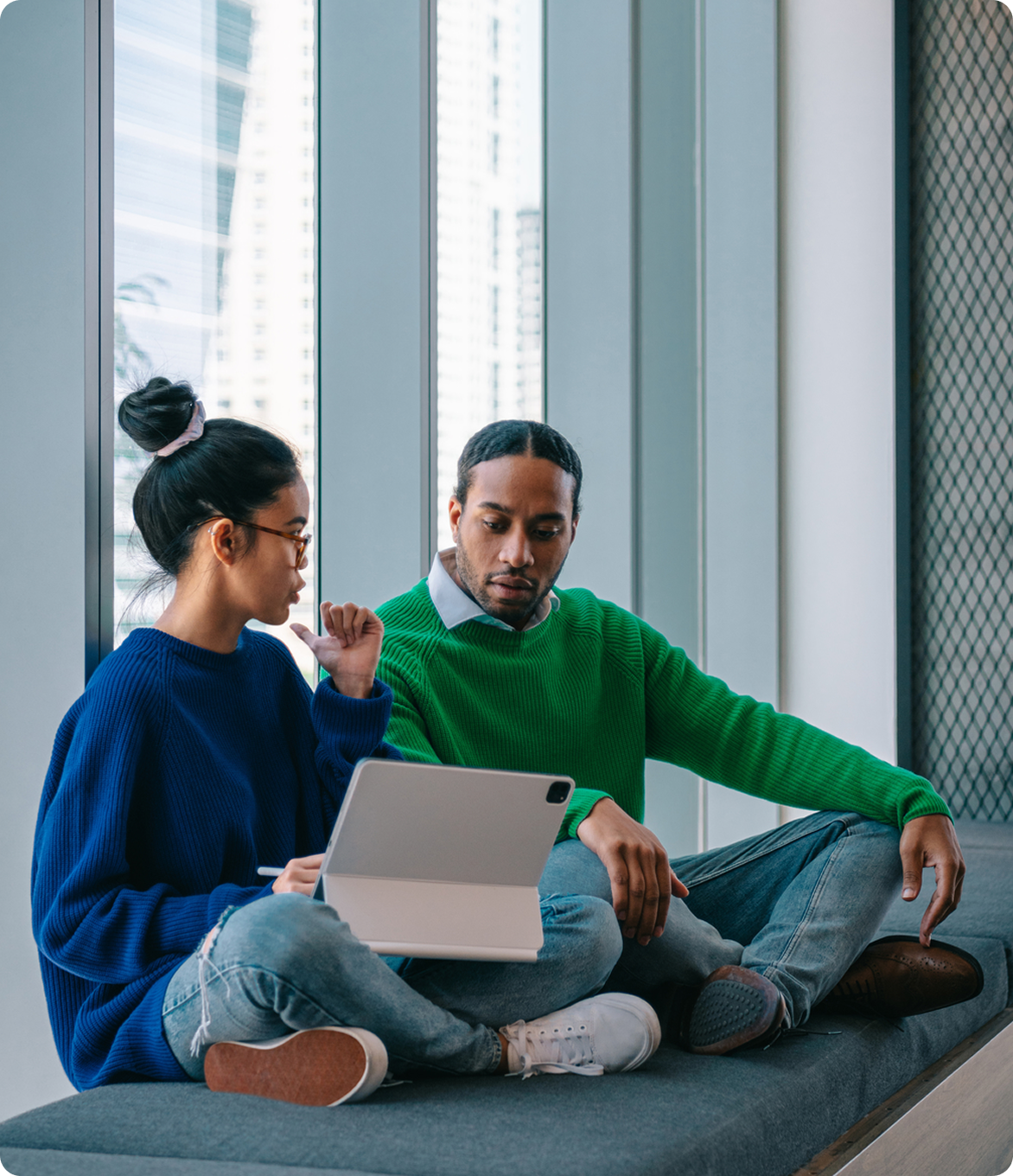 Two college students looking at a tablet