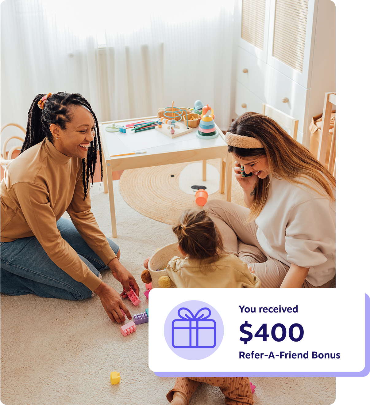 A woman and two children happily playing with toys on the floor
