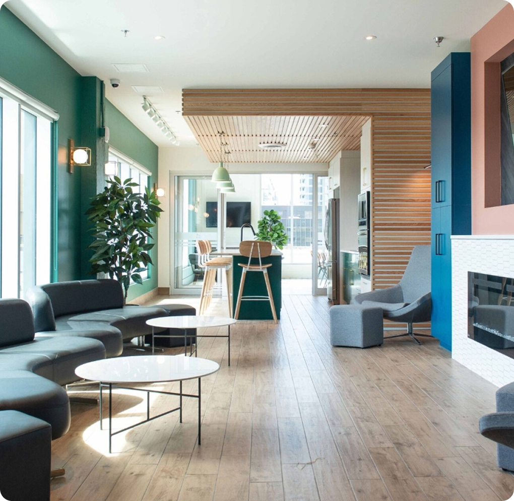 A modern office featuring blue walls and warm wood floors, creating a stylish and inviting workspace.
