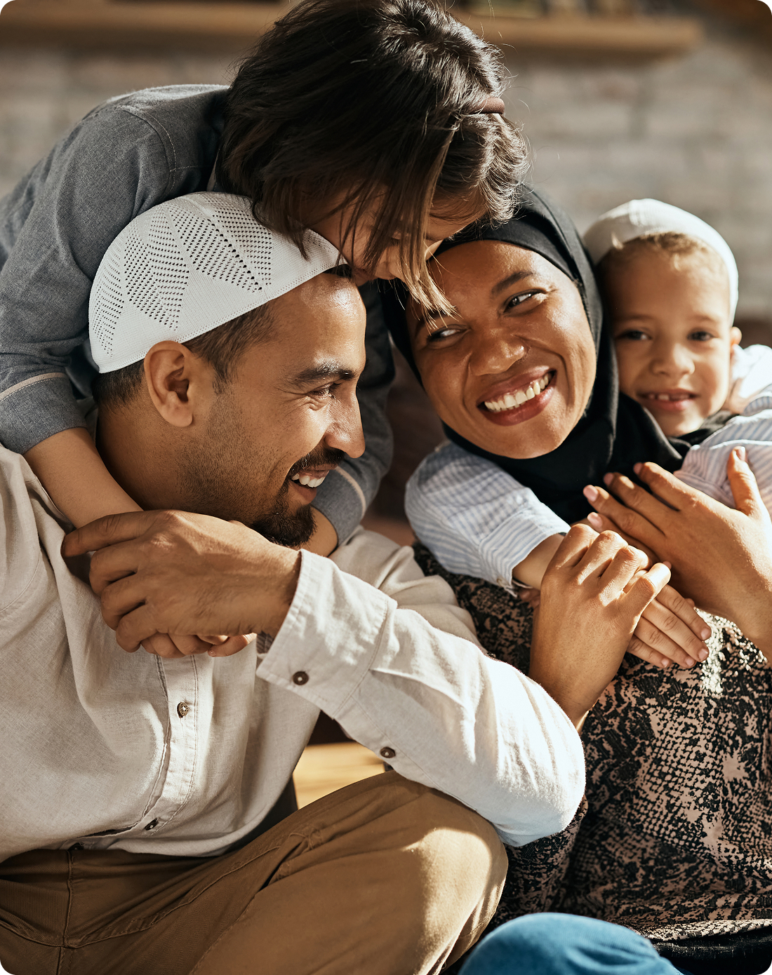A Muslim family sitting together on the floor, sharing a moment of connection and warmth.