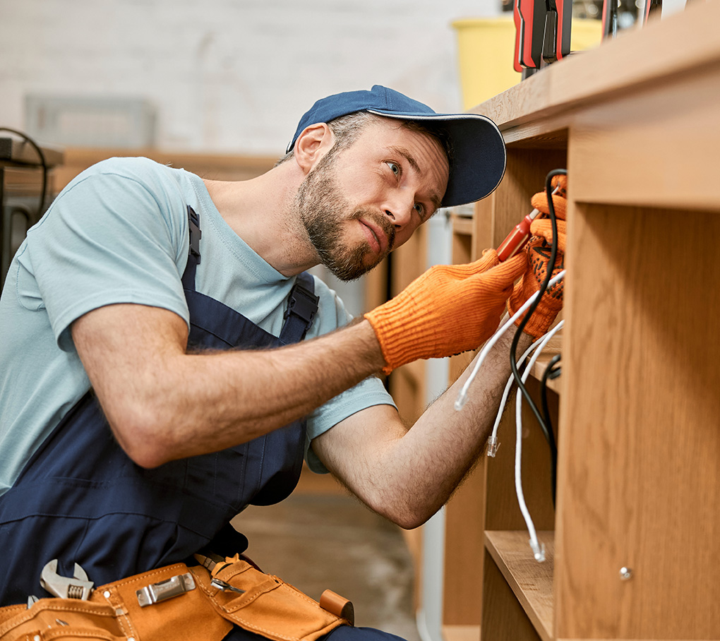 Male electrician working on a desk