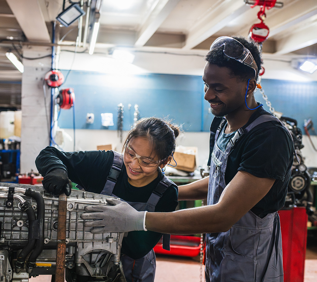 Two trade apprentices working on a machine